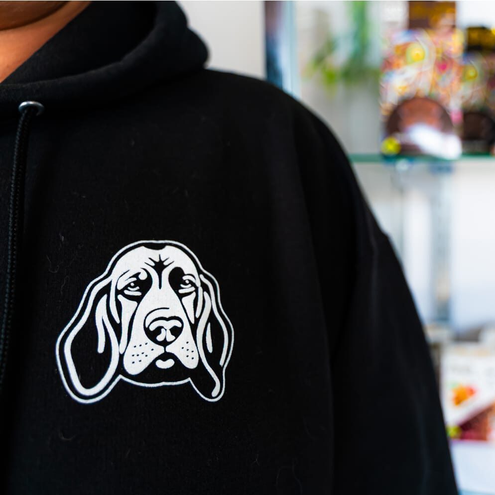 close up of green roads cannabis logo on employee sweatshirt